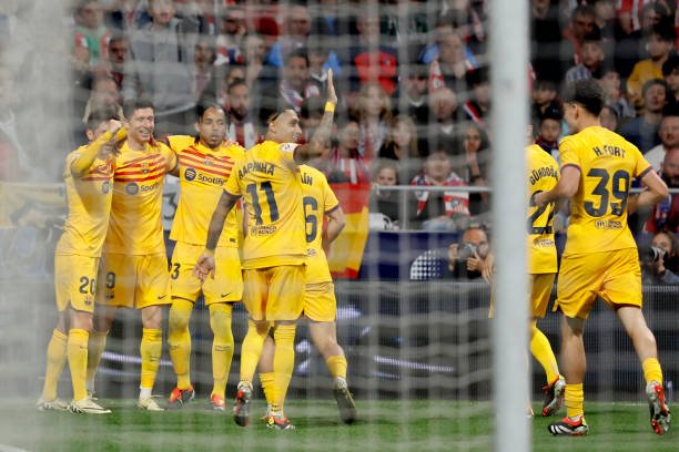 Barcelona's Polish forward #09 Robert Lewandowski (2L) celebrates scoring his team's second goal during the Spanish league football match between Club Atletico de Madrid and FC Barcelona at the Metropolitano stadium in Madrid on March 17, 2024. (Photo by OSCAR DEL POZO / AFP) (Photo by OSCAR DEL POZO/AFP via Getty Images)