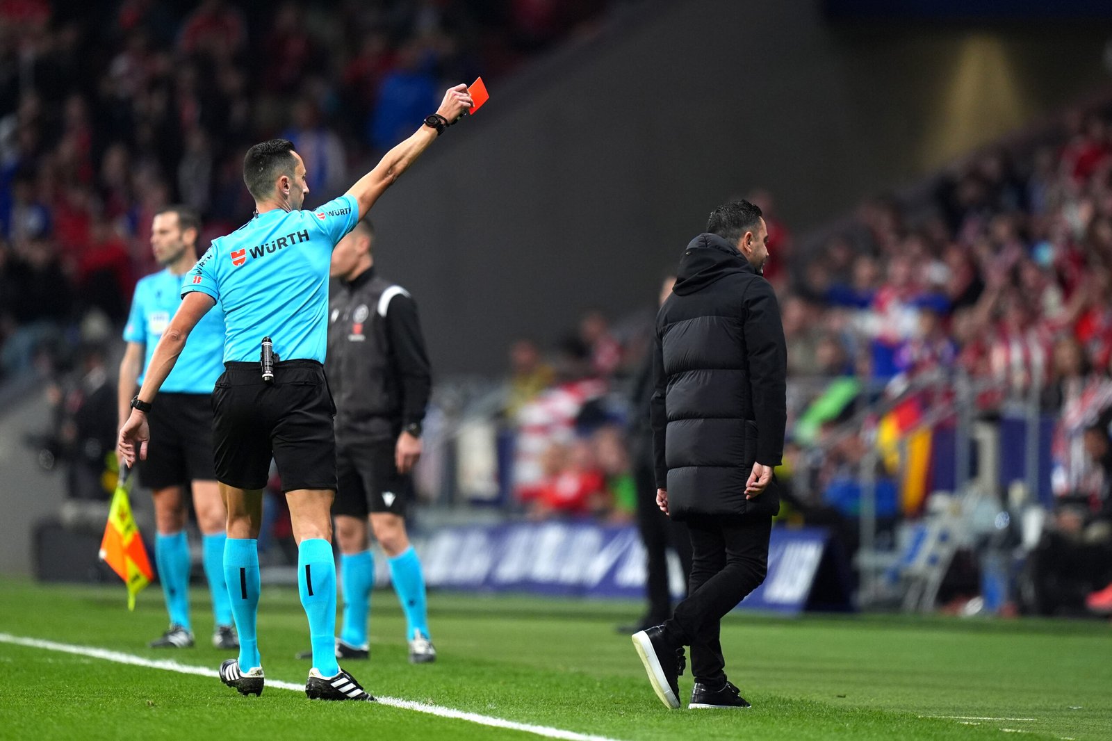 MADRID, SPAIN - MARCH 17: Match Referee Jose Maria Sanchez Martinez shows Xavi, Head Coach of FC Barcelona, a red card during the LaLiga EA Sports match between Atletico Madrid and FC Barcelona at Civitas Metropolitano Stadium on March 17, 2024 in Madrid, Spain. (Photo by Angel Martinez/Getty Images)
