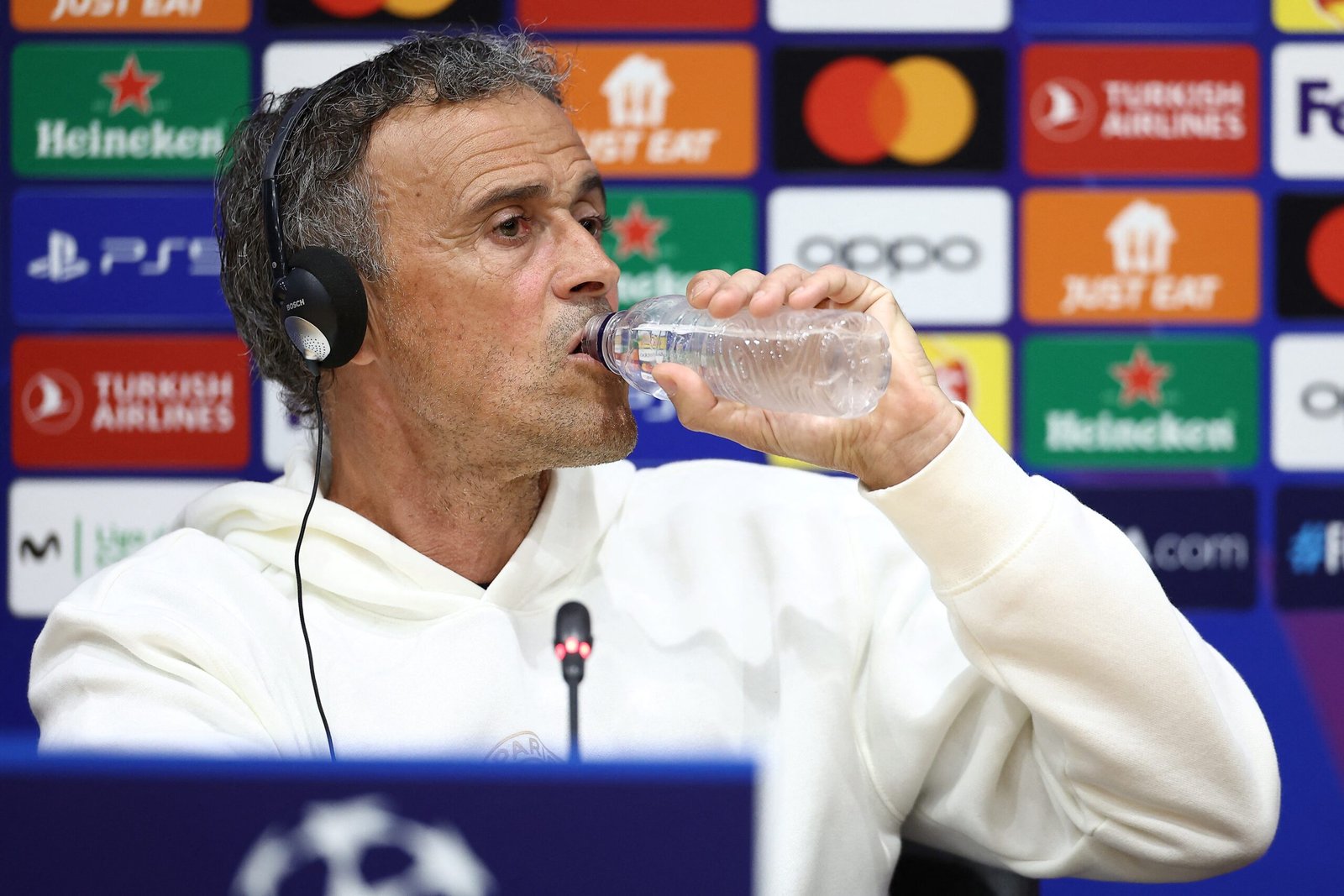 Paris Saint-Germain's Spanish headcoach Luis Enrique drinks water during a press conference on the eve of their UEFA Champions League quarter-final second leg football match against FC Barcelona at the Estadi Olimpic Lluis Companys in Barcelona on April 15, 2024. (Photo by FRANCK FIFE / AFP) (Photo by FRANCK FIFE/AFP via Getty Images)