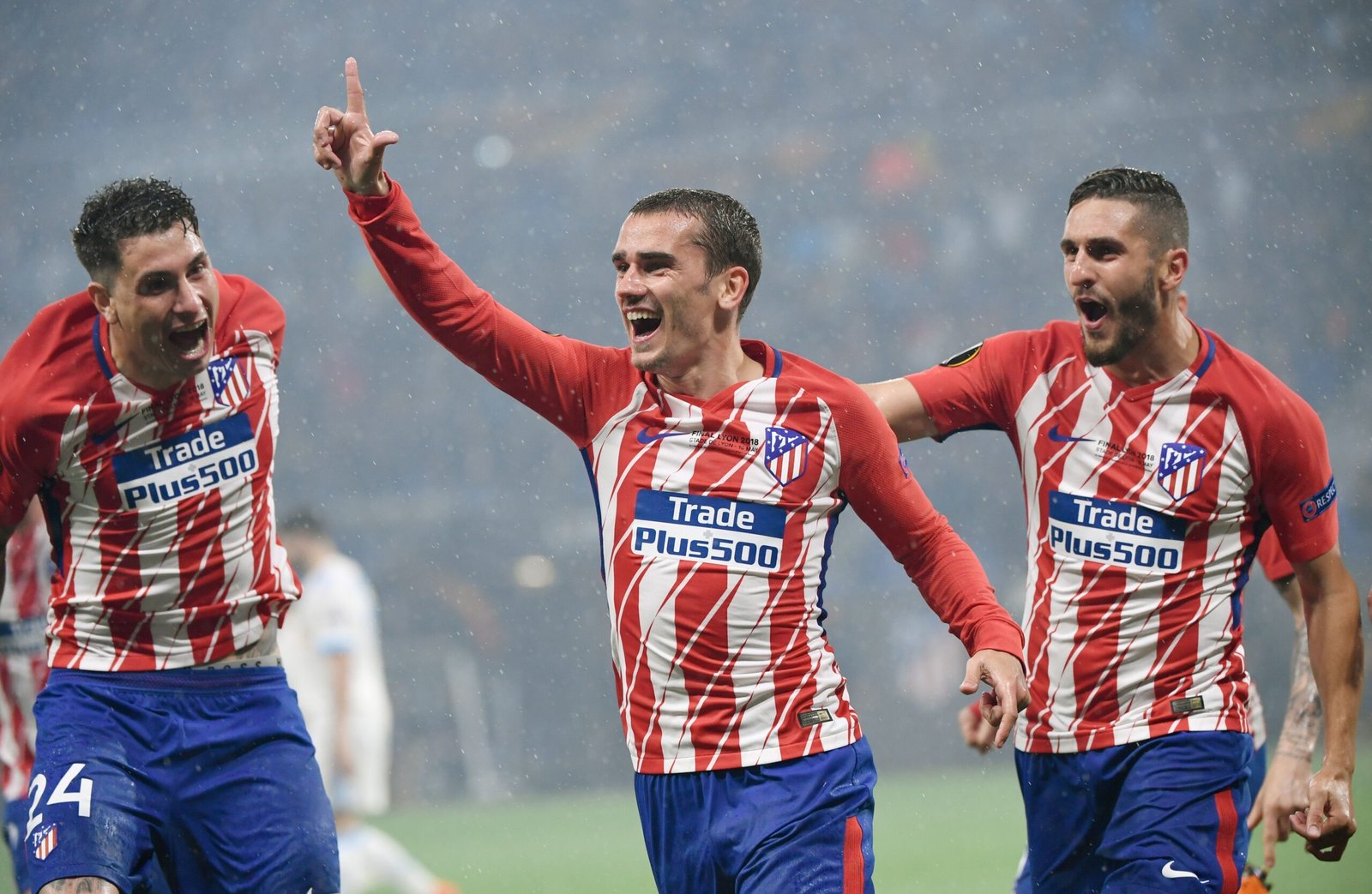 Atletico Madrid's French forward Antoine Griezmann (C) celebrates with Atletico Madrid's Uruguayan defender Jose Gimenez (L) and Atletico Madrid's Spanish midfielder Koke after scoring his second goal during the UEFA Europa League final football match between Olympique de Marseille and Club Atletico de Madrid at the Parc OL stadium in Decines-Charpieu, near Lyon on May 16, 2018. (Photo by Philippe DESMAZES / AFP) (Photo credit should read PHILIPPE DESMAZES/AFP via Getty Images)
