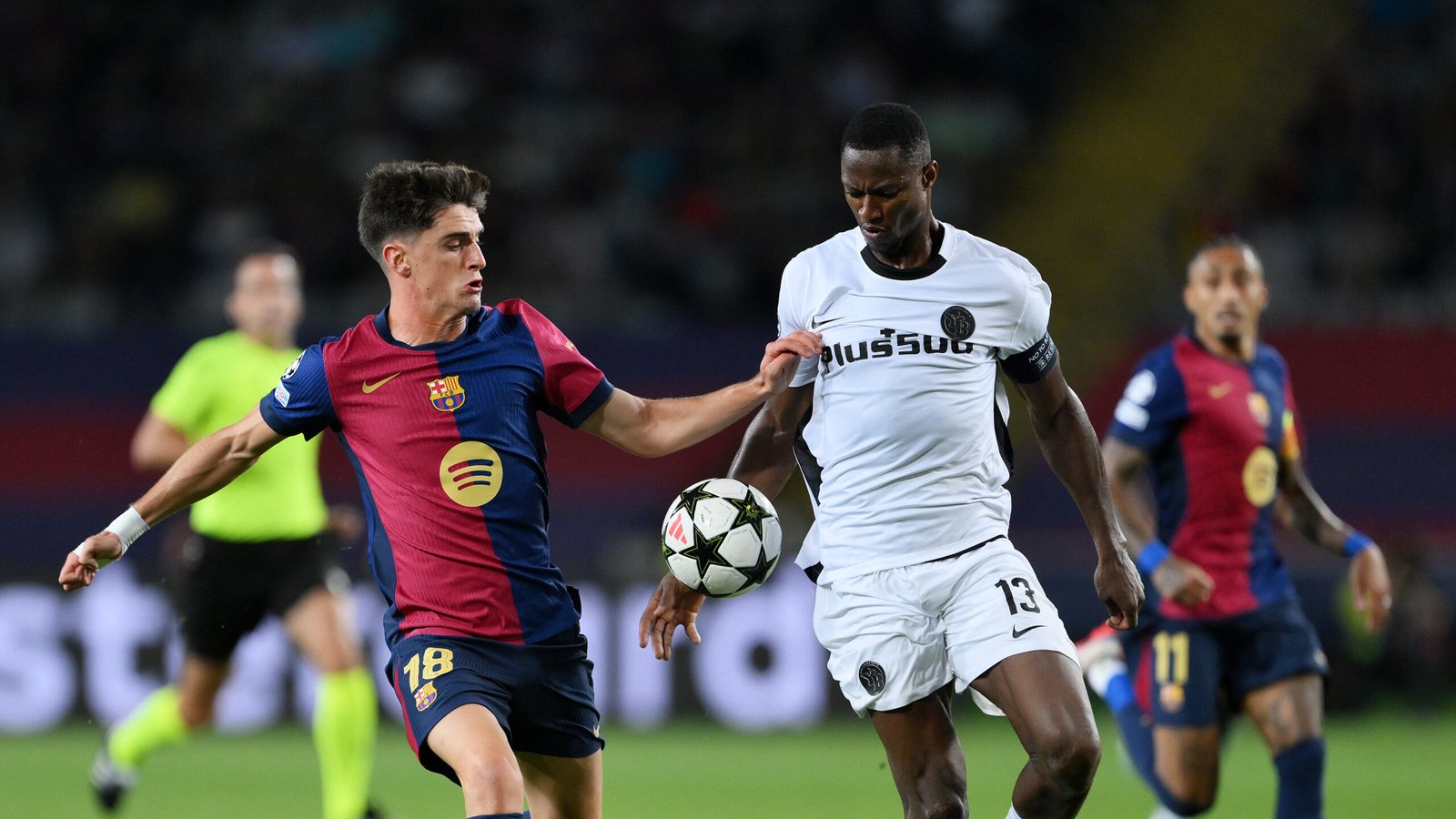 BARCELONA, SPAIN - OCTOBER 01: Pau  of Bayer 04 Leverkusen is challenged by Mohamed Camara of BSC Young Boys during the UEFA Champions League 2024/25 League Phase MD2 match between FC Barcelona and BSC Young Boys at Estadi Olimpic Lluis Companys on October 01, 2024 in Barcelona, Spain. (Photo by David Ramos/Getty Images)