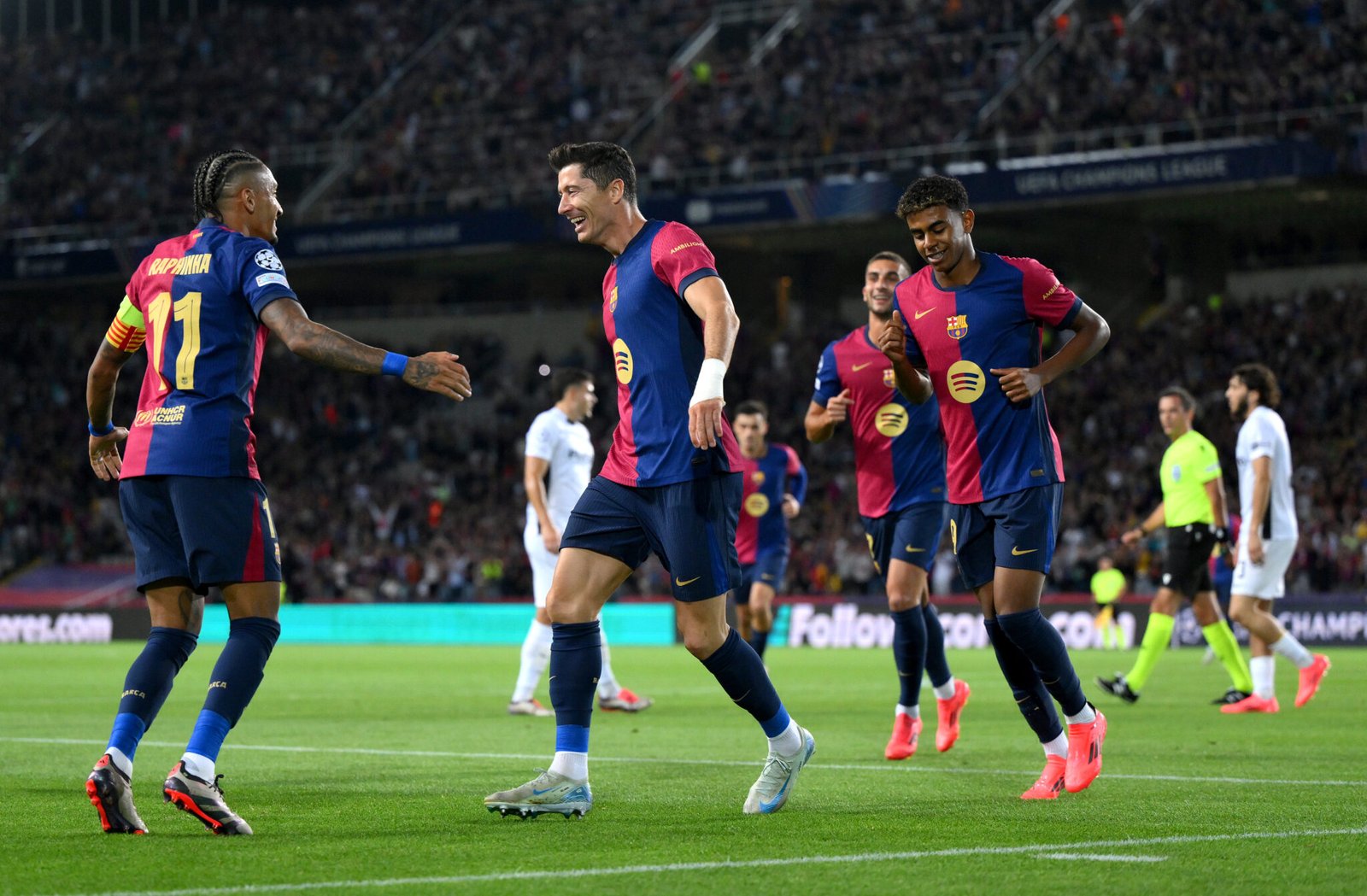 BARCELONA, SPAIN - OCTOBER 01: Robert Lewandowski of FC Barcelona celebrates scoring his team's first goal with teammate Raphinha during the UEFA Champions League 2024/25 League Phase MD2 match between FC Barcelona and BSC Young Boys at Estadi Olimpic Lluis Companys on October 01, 2024 in Barcelona, Spain. (Photo by David Ramos/Getty Images)