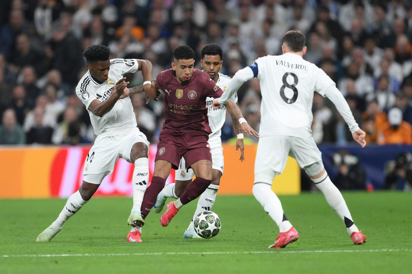 MADRID, SPAIN - FEBRUARY 19: Savinho of Manchester City is challenged by Aurelien Tchouameni, Rodrygo and Federico Valverde of Real Madrid during the UEFA Champions League 2024/25 League Knockout Play-off second leg match between Real Madrid C.F. and Manchester City at Santiago Bernabeu Stadium on February 19, 2025 in Madrid, Spain. (Photo by David Ramos/Getty Images)